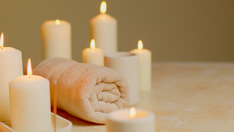 Still-Life-Of-Lit-Candles-With-Incense-Stick-And-Soft-Towels-As-Part-Of-Relaxing-Spa-Day-Decor